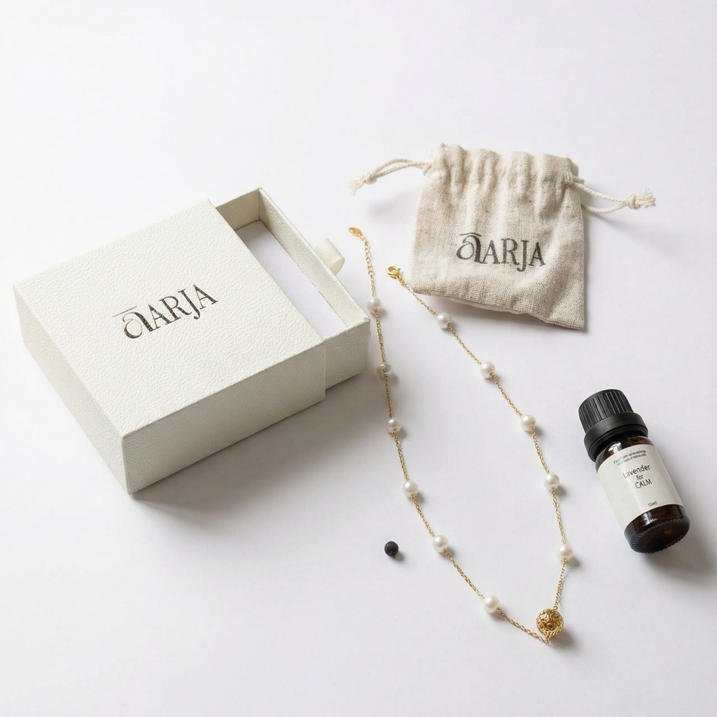 Aromatherapy Jewelry set with necklace, small bottle, and pouch on a white background with 'AARJA' branding.
