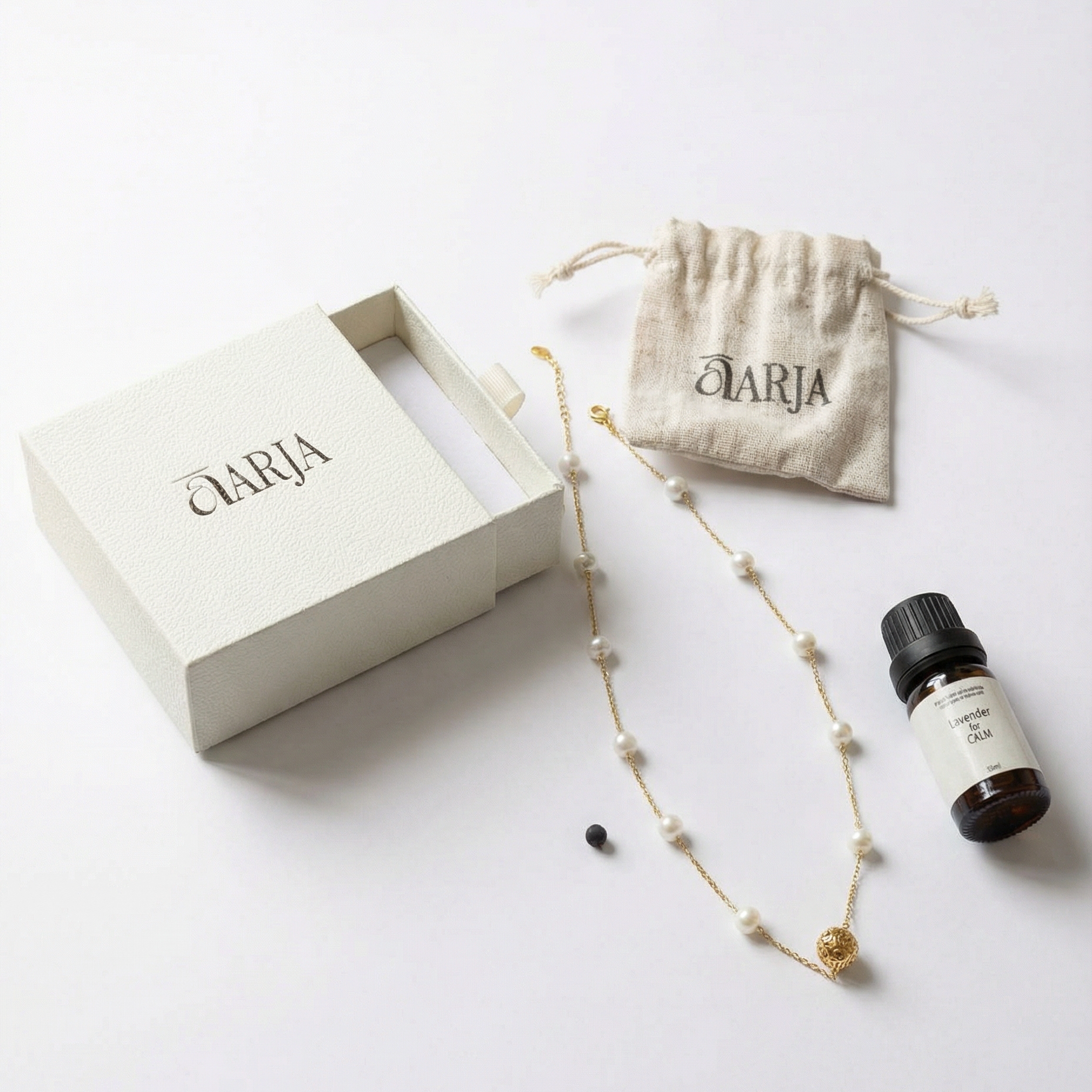 Aromatherapy Jewelry set with necklace, small bottle, and pouch on a white background with 'AARJA' branding.